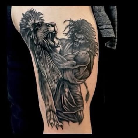 Blackwork lion and warrior thigh tattoo by Clayton