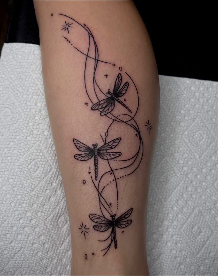 Fine line dragonfly and celestial calf tattoo by Elleneese