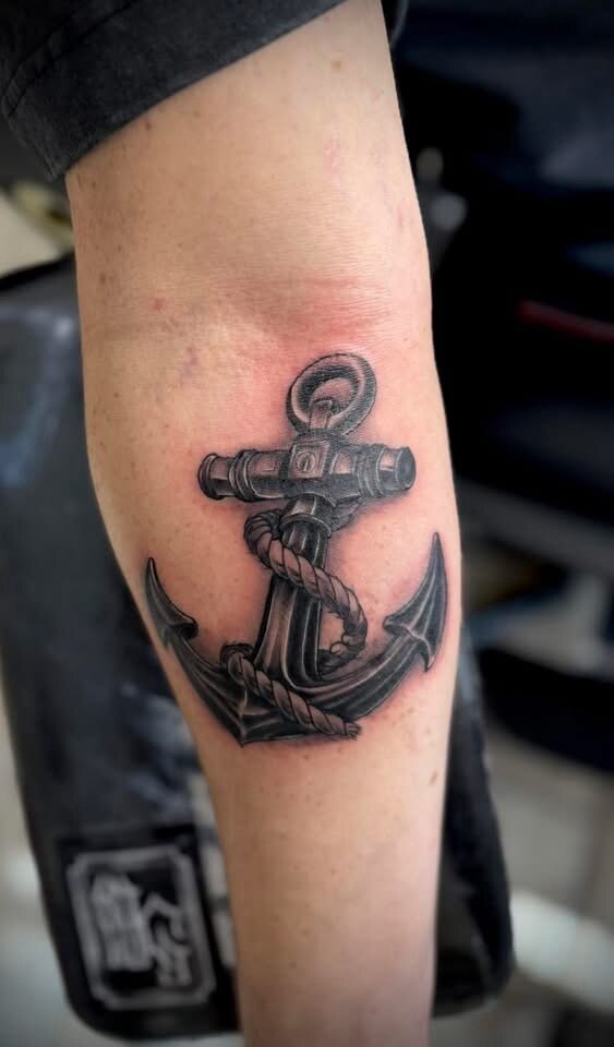 Traditional anchor and rope forearm tattoo by Sean